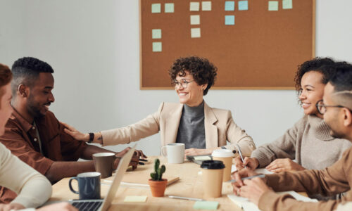 Smiling colleagues working together at a conference table