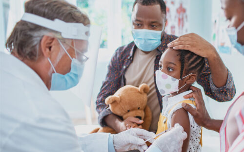 Doctor administering medicine to a child